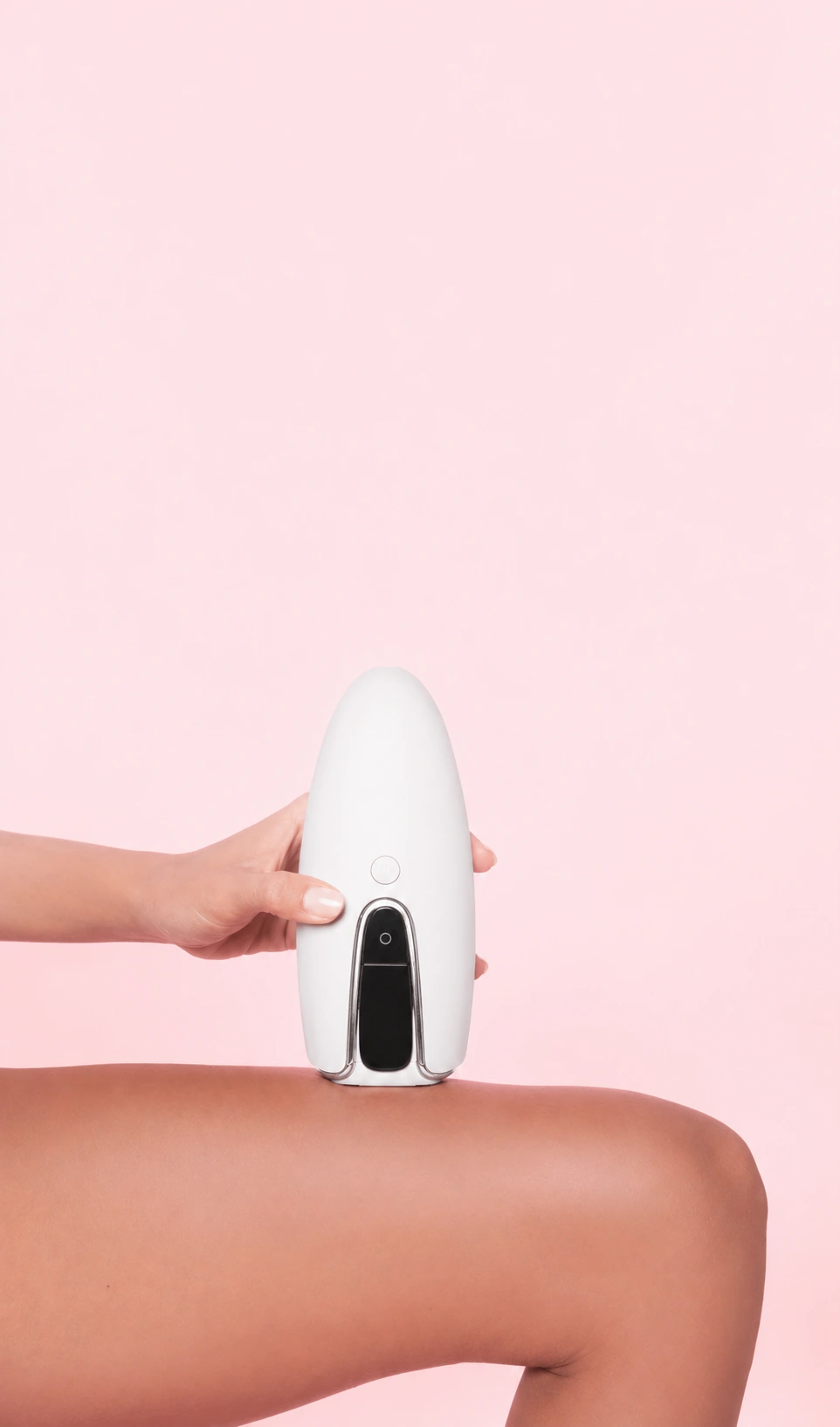 Juujo IPL Hair Removal handset on clean pastel pink background